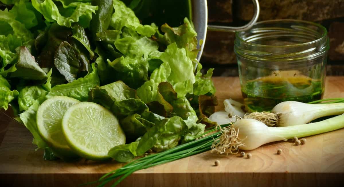 lettuce, limes, and green onions on a board - to your health nutrition